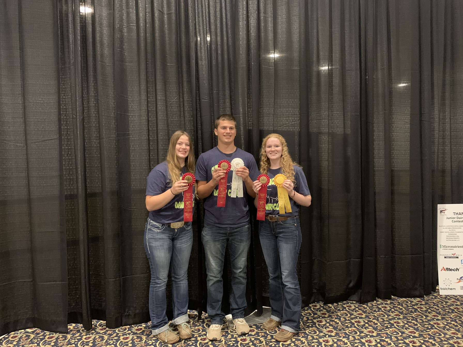 A group of three youth posting together. 